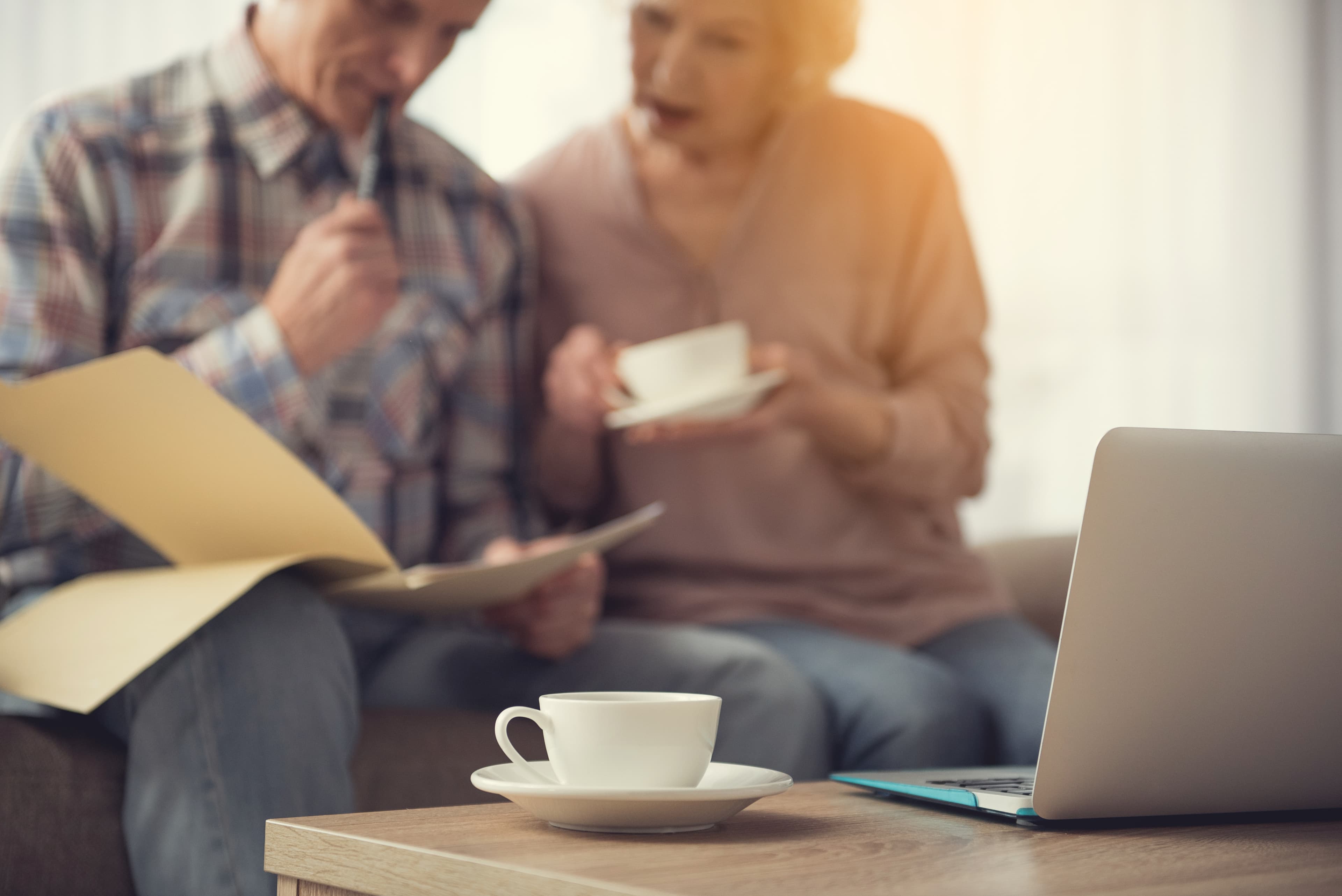 Elderly couple reviewing documents together with concern